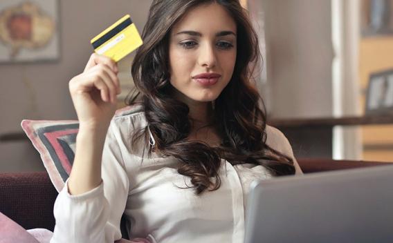 Young woman using credit card