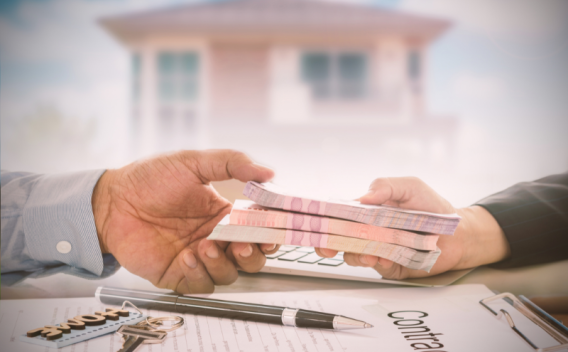 Banker handing a customer a stash of money