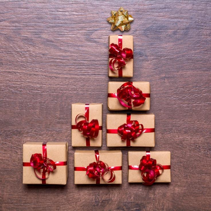 Creative concept with gift boxes Christmas tree of gifts on a wooden table