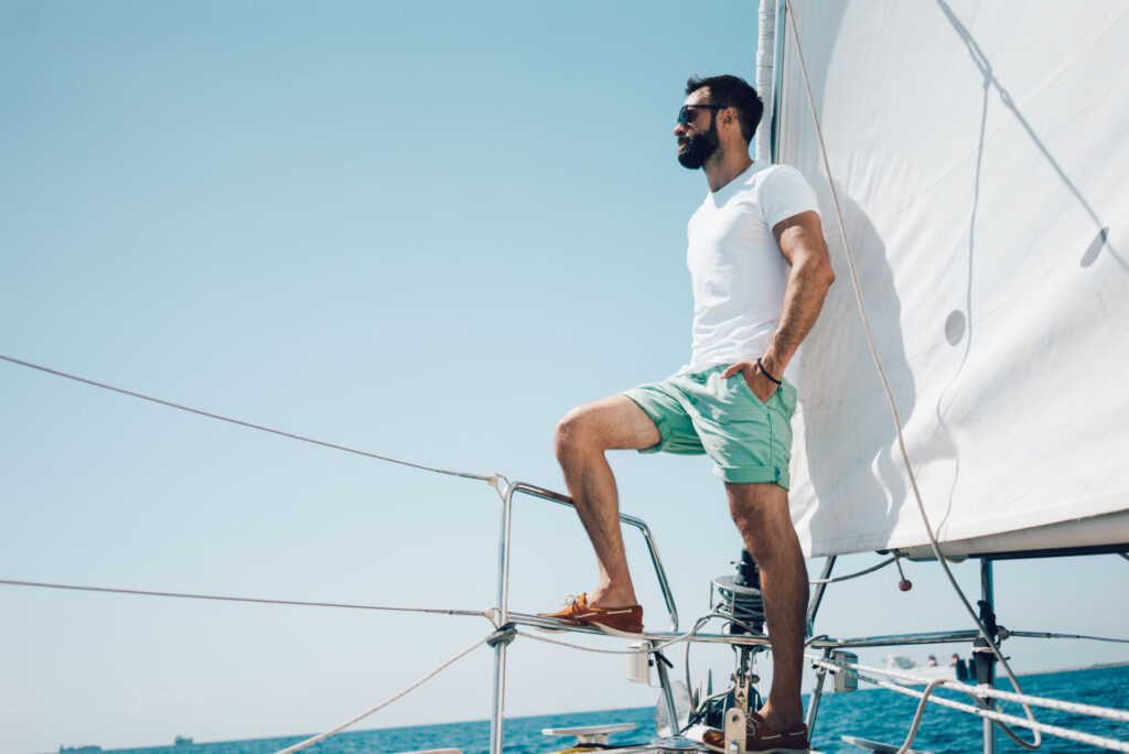 A man sailing on the boat he purchased with a credit union vehicle loan.