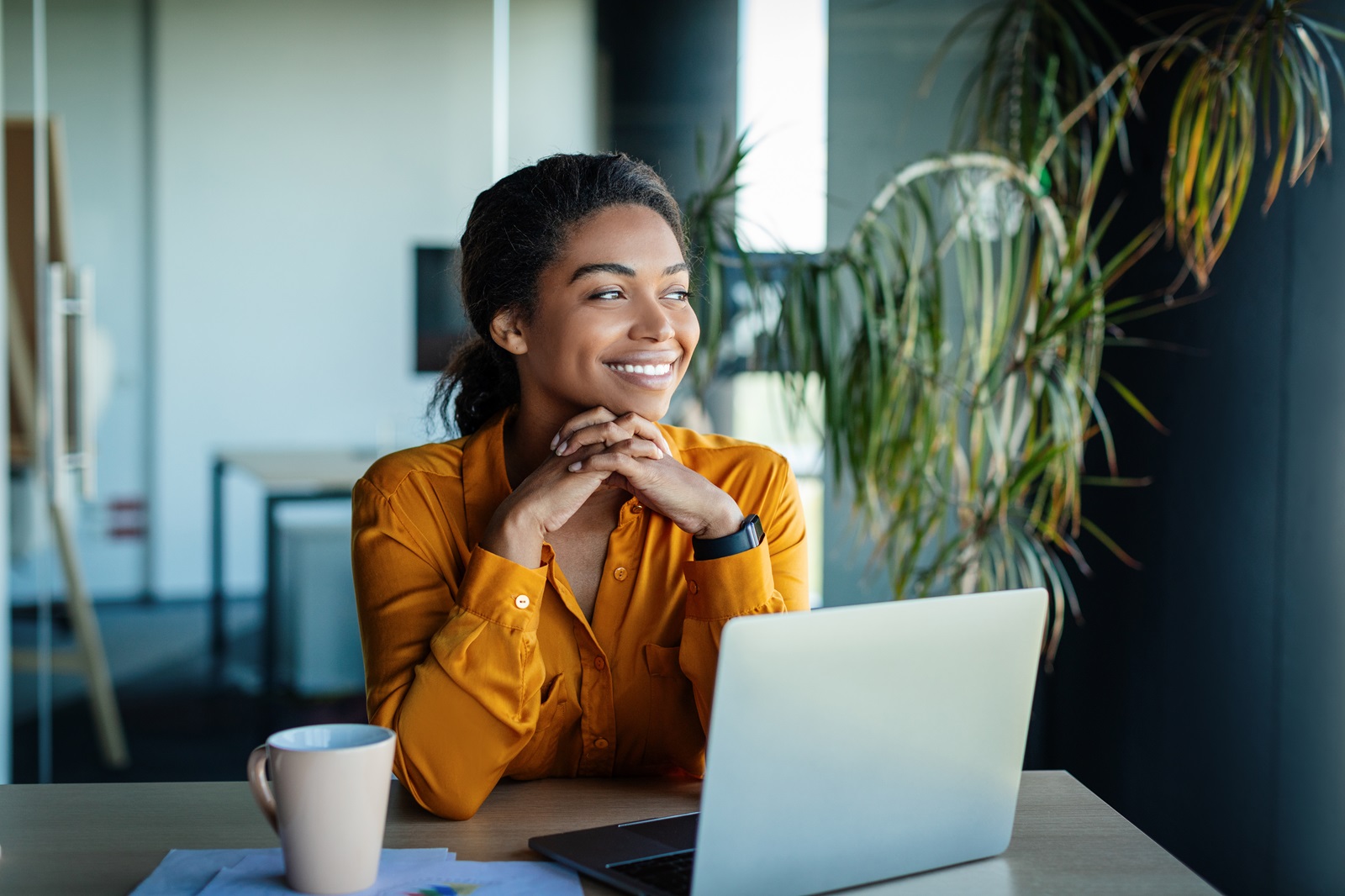 A young woman smiles at the possibility of consolidating her debt with a consumer loan.