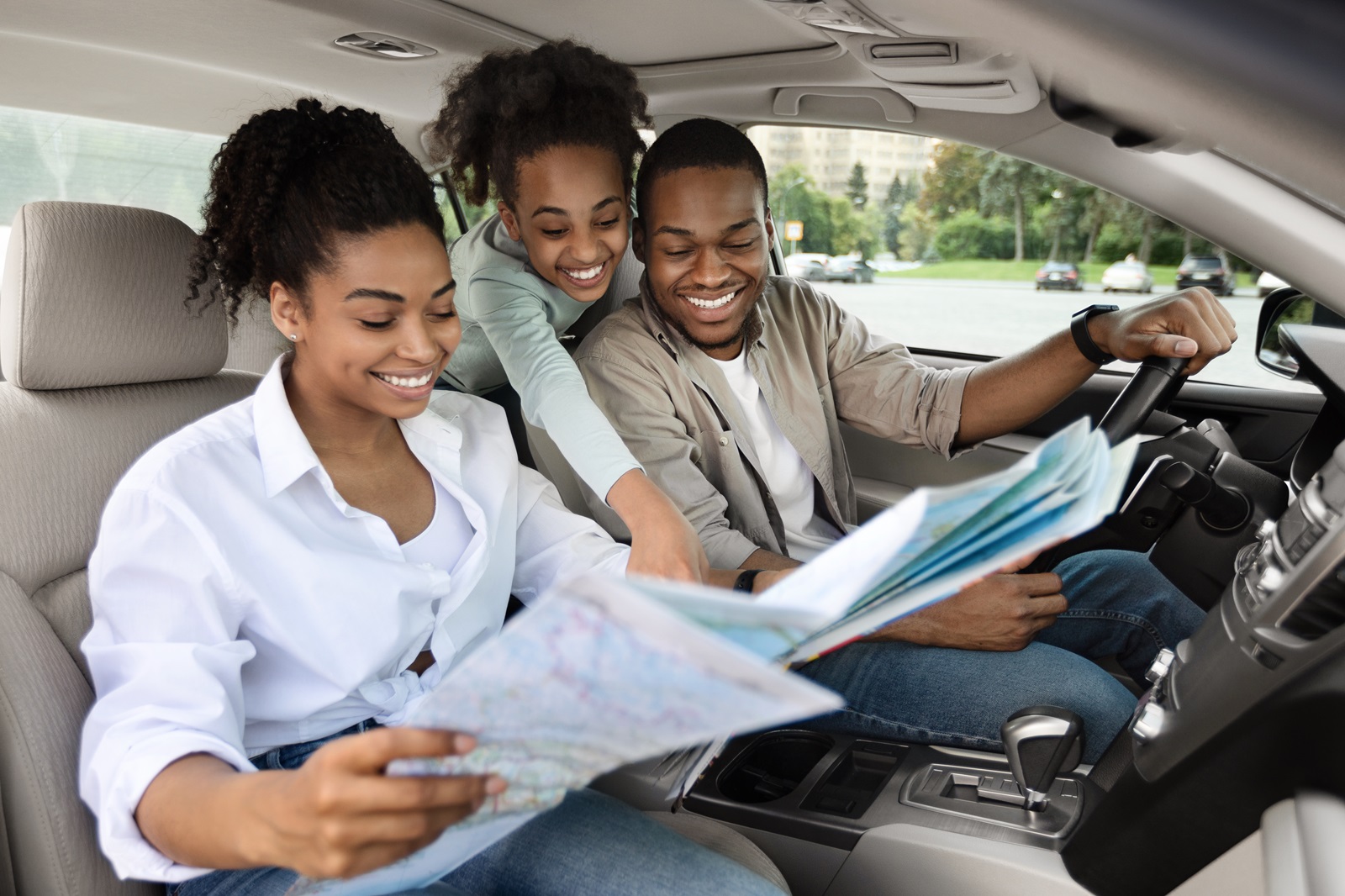 A young family maps out their first road trip in a new vehicle they financed with a consumer loan.