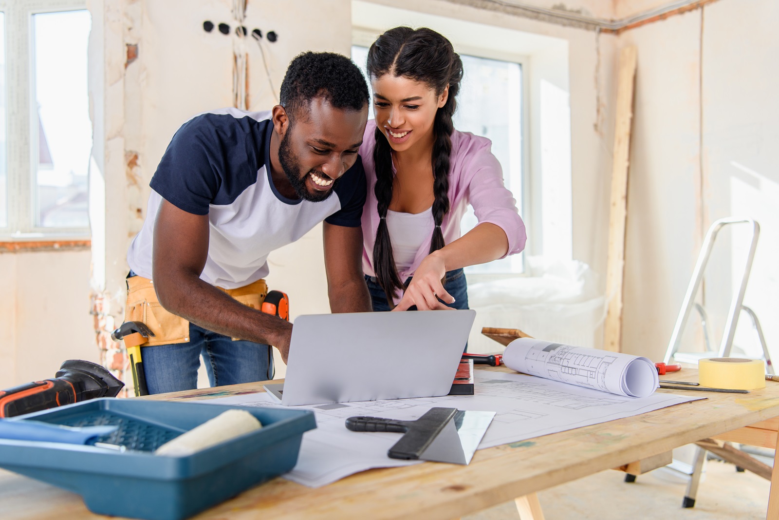 A young couple tackle a home improvement project together.